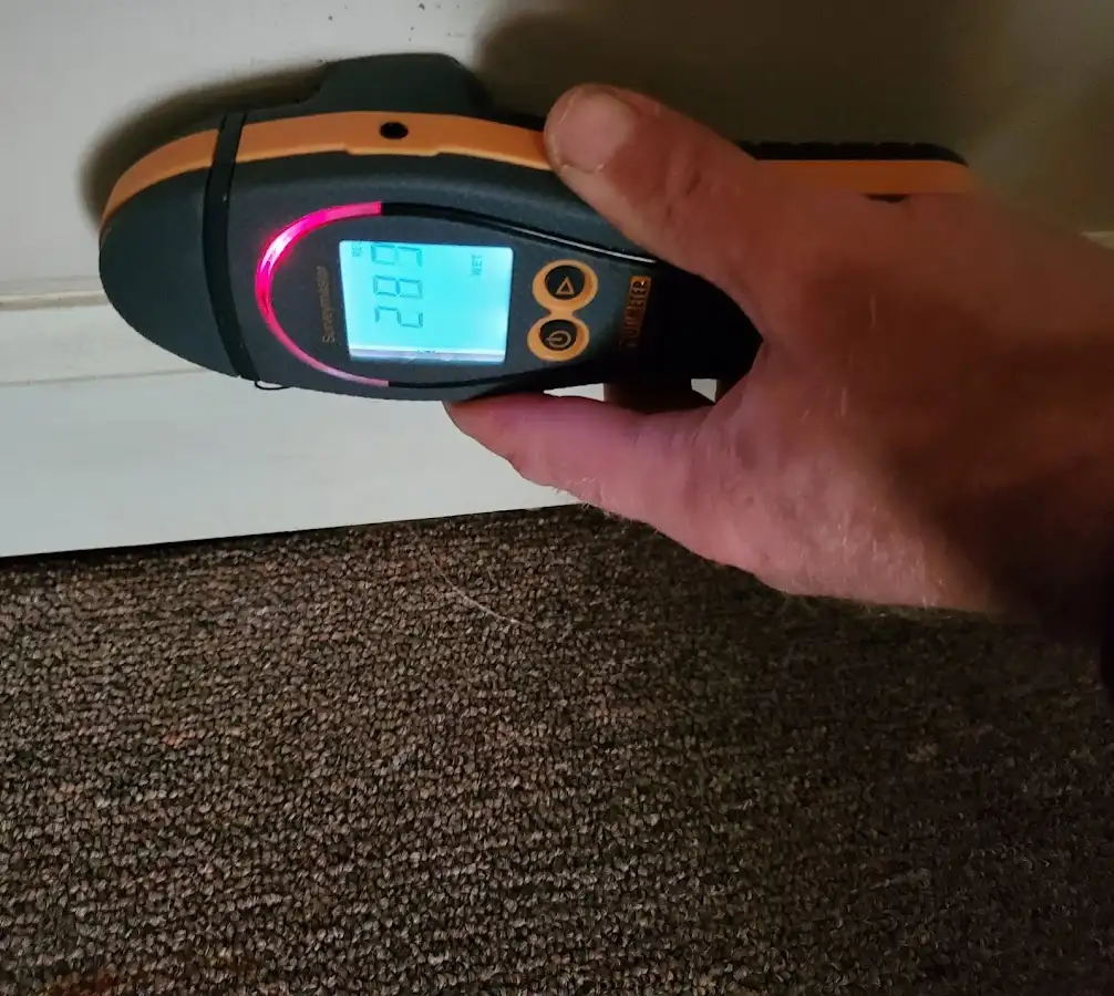 Moisture detection at baseboard during Storm Damage Restoration in Ulysses